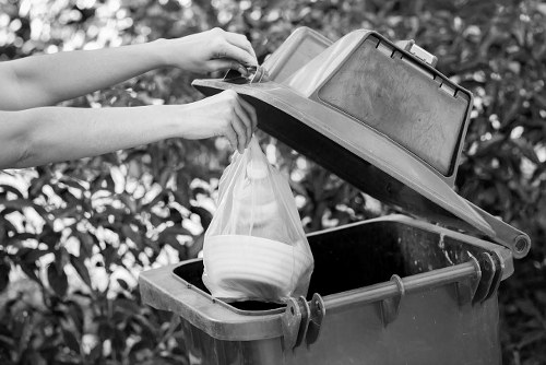 Technician sorting old refrigerators for recycling